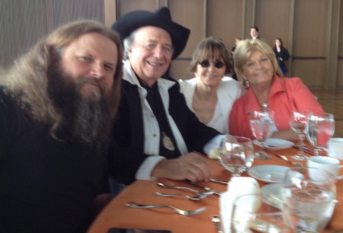 Four people seated together at a dinner table